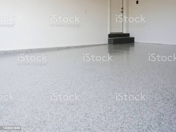 Red garage cabinetry and epoxy floor