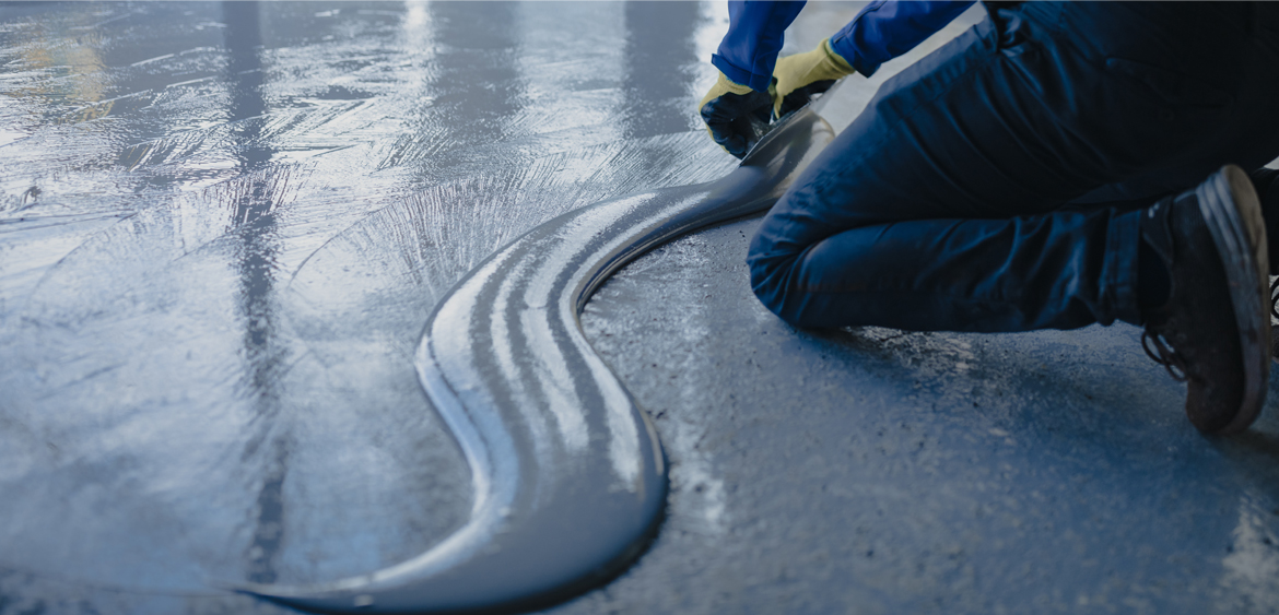 Professional installer applying an epoxy floor coating
